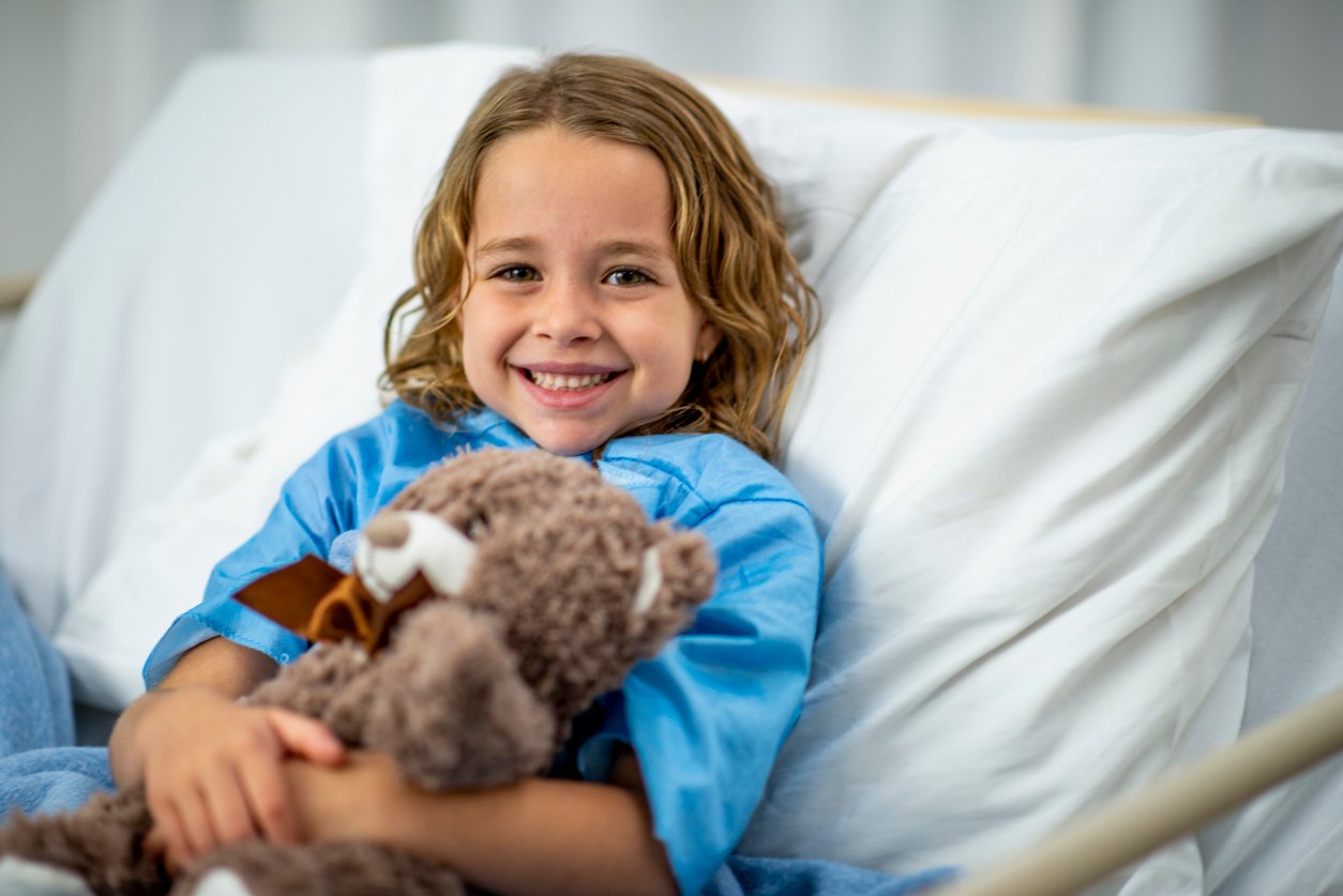 little-girl-in-hospital-bed-with-teddybear