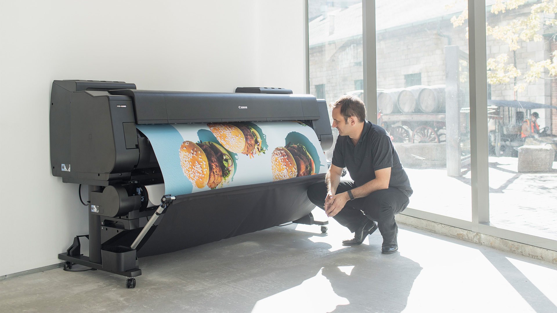 man-printing-on-canon-wide-format-printer